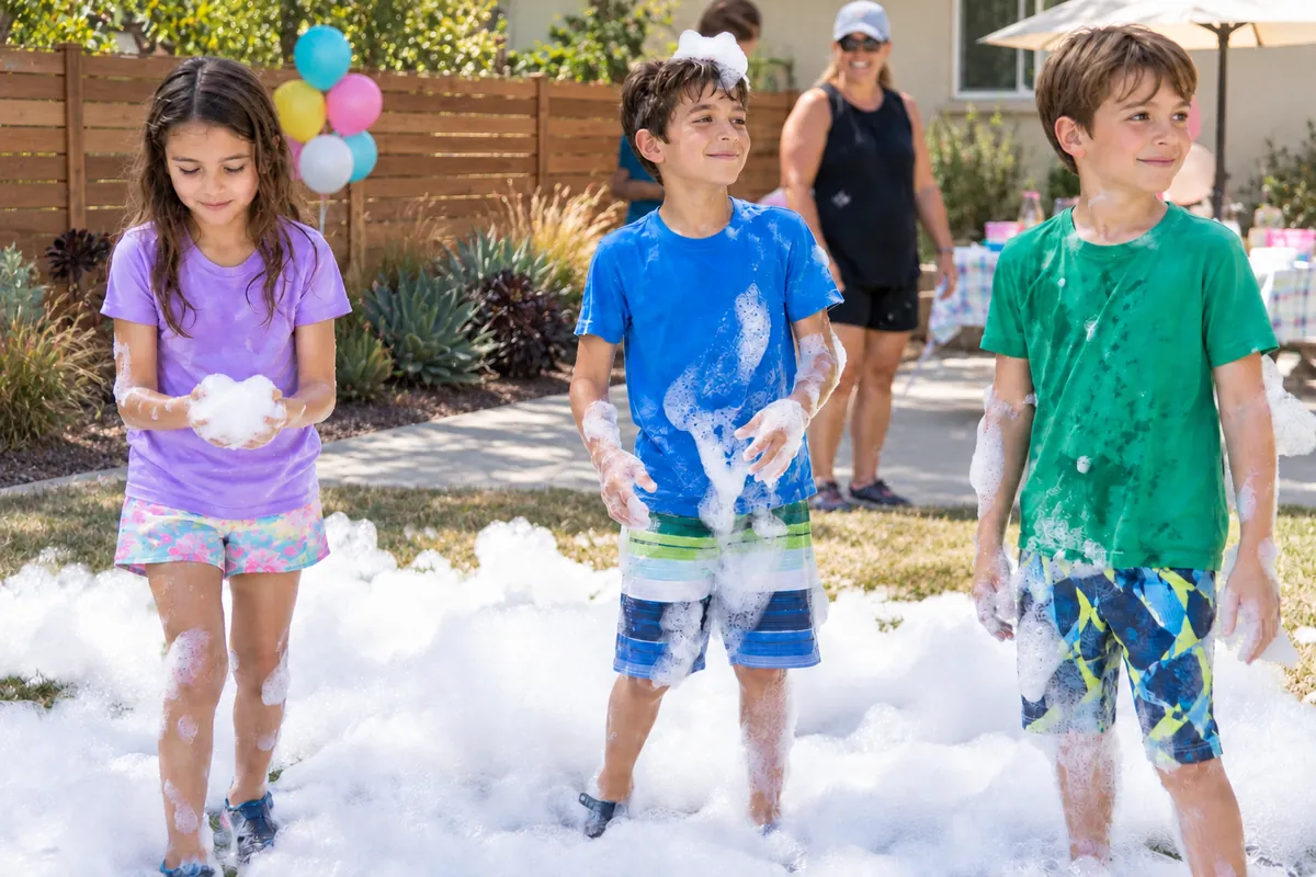 Kids playing in foam at a backyard foam party in LA